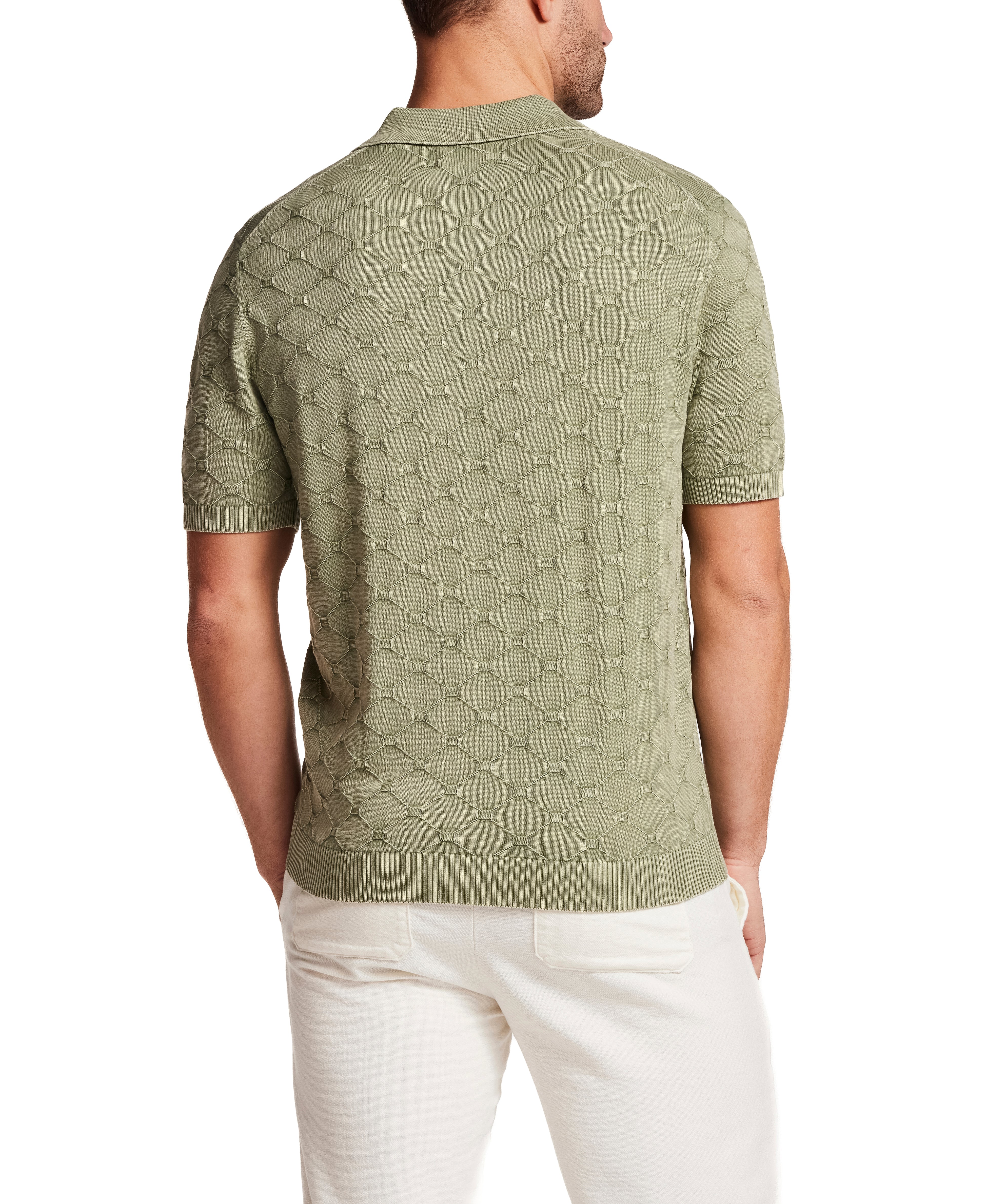 Back view of a man wearing the Stonewash Diamond Sweater Polo in Sea Grass, showcasing the subtle diamond knit texture.