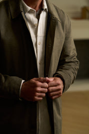 Sueded Jacket in Olive displayed on a model, showcasing the button-up design and subtle texture.