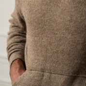 Close-up of the soft fabric of the Sweater Knit Hoodie in Brown, showcasing the pullover style and front pouch pocket.