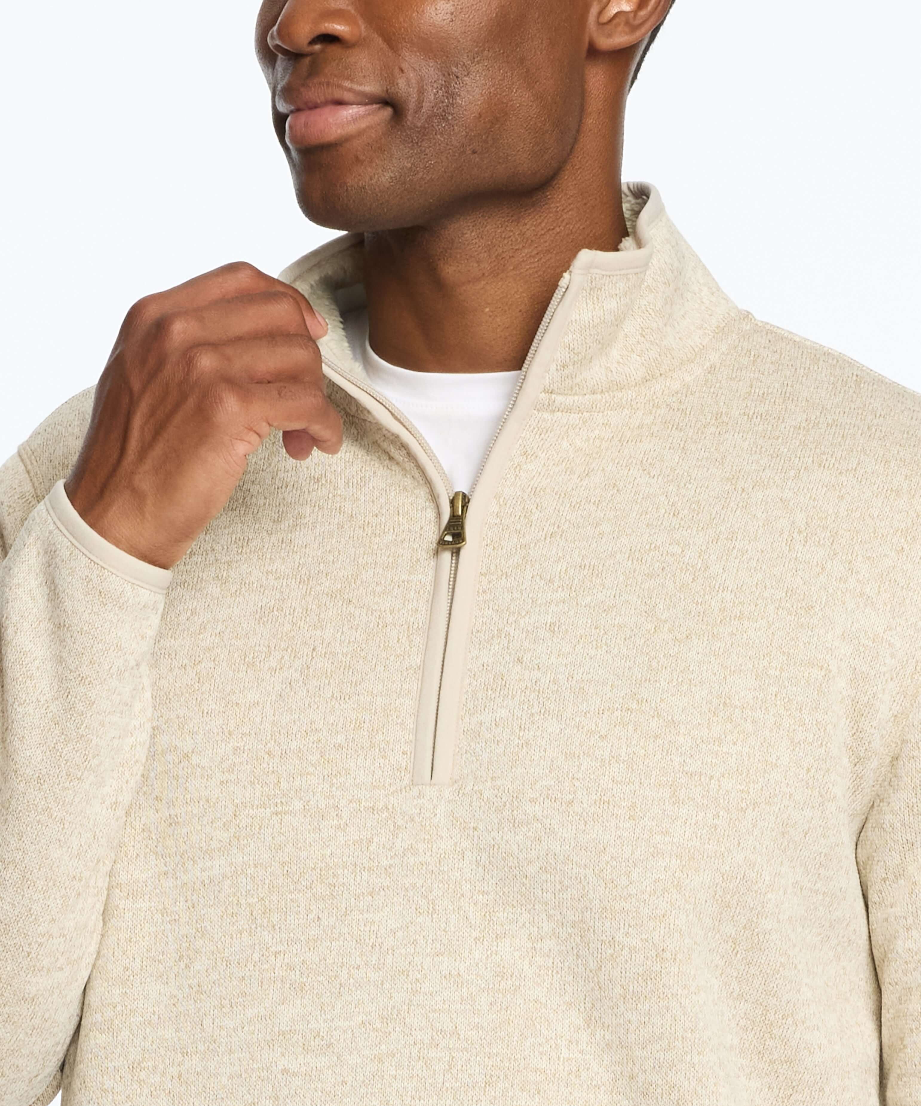 Man wearing a stone-colored sweaterfleece pullover with sherpa trim and quarter zip, showcasing style and warmth.