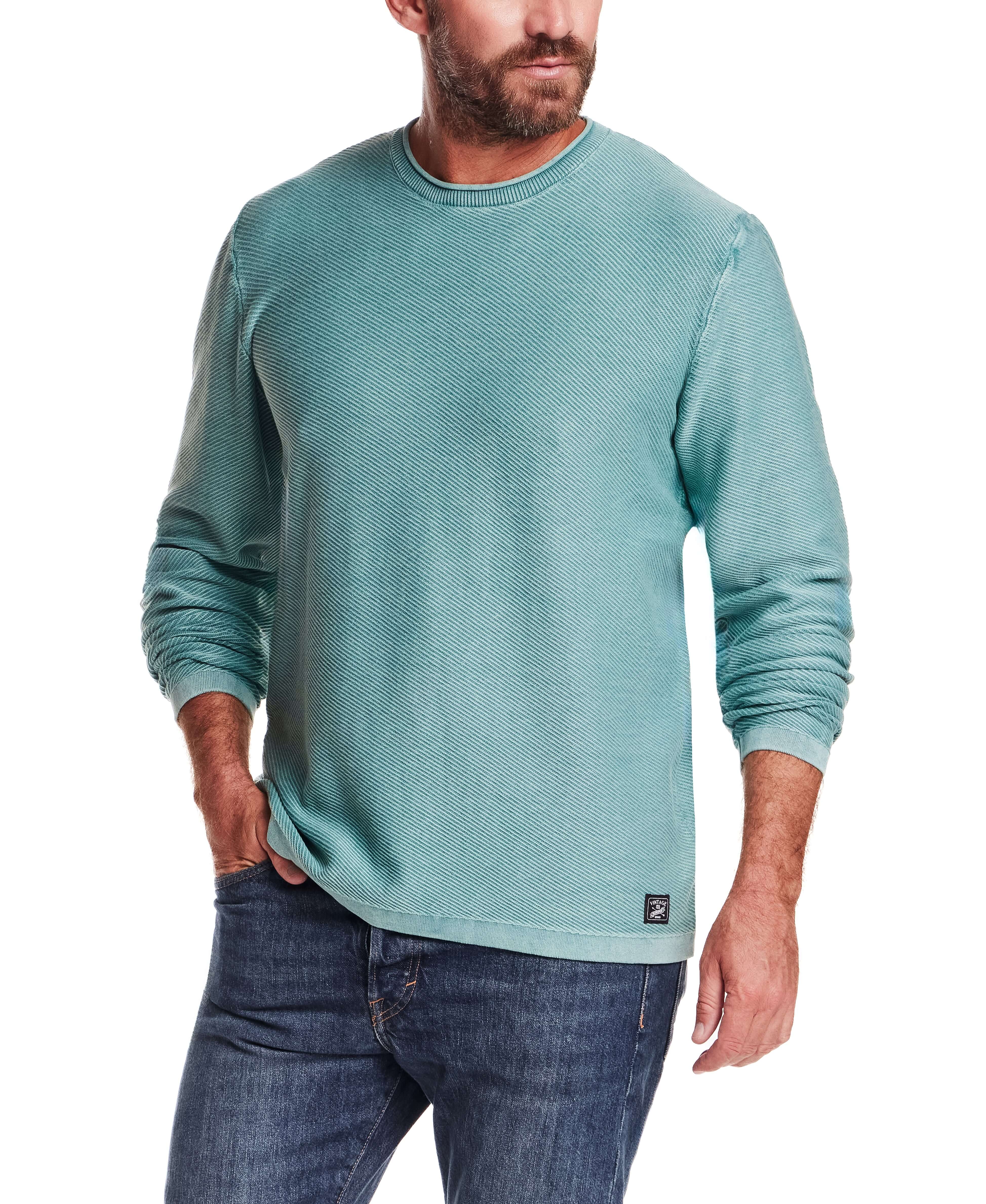 Twill Stonewash Sweater in Adriatic Blue worn by a model, highlighting its classic roll-neck design and airy texture.