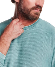 Close-up of a man wearing the Twill Stonewash Sweater in Adriatic Blue, showcasing its soft twill texture.