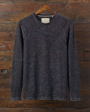 Twill Stonewash Sweater in Jet Black hanging on a wooden hanger, showcasing its vintage look and airy twill texture.