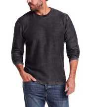 Stylish man wearing a Twill Stonewash Sweater in Jet Black, featuring a classic crew neck and ribbed detail.