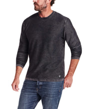 Twill Stonewash Sweater in Jet Black worn by a man, showcasing its classic roll-neck design and texture.