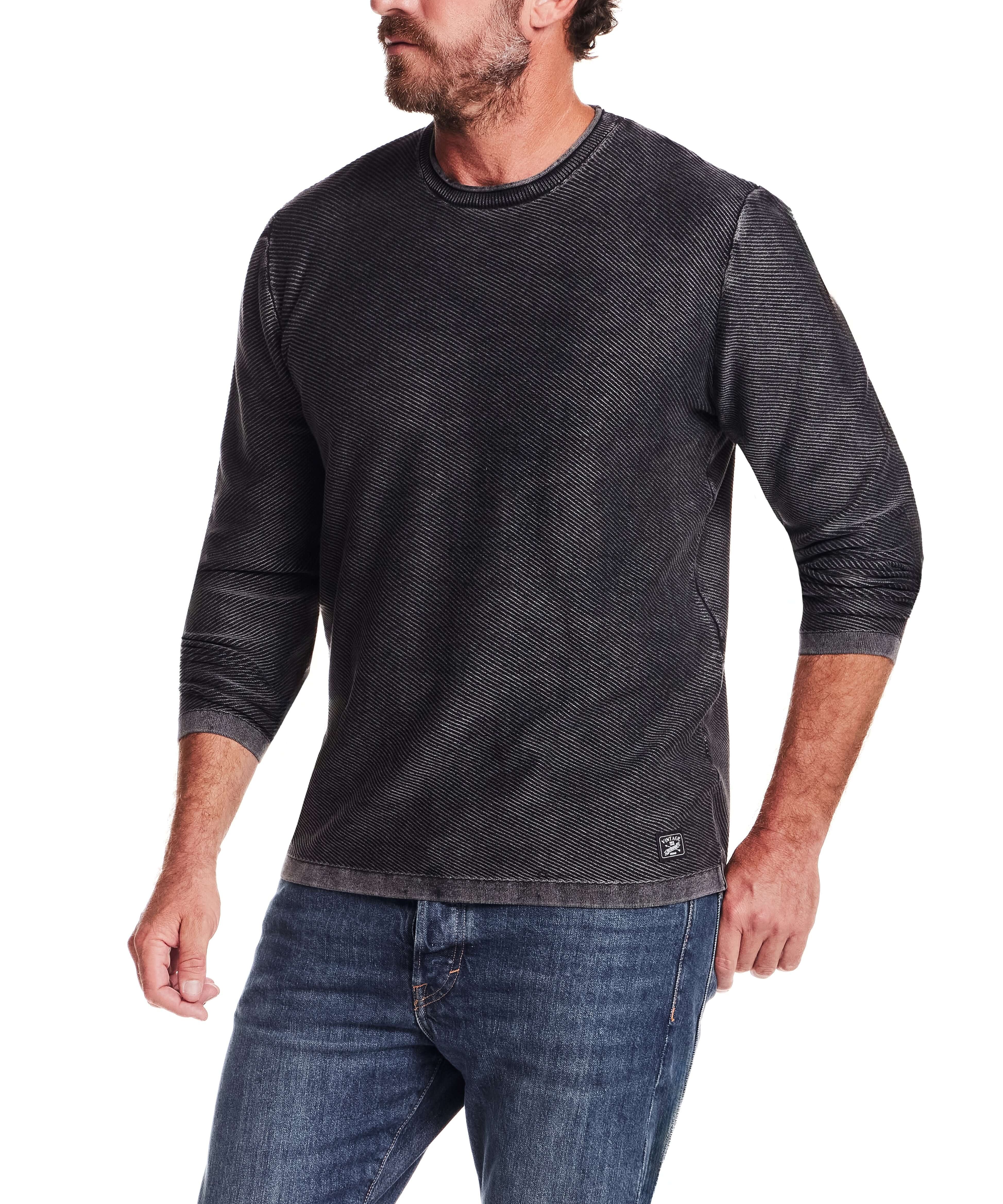 Twill Stonewash Sweater in Jet Black worn by a man, showcasing its classic roll-neck design and texture.
