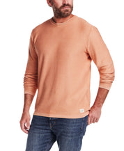 Twill Stonewash Sweater in Shell Coral worn by a man, featuring a classic roll-neck and textured design.