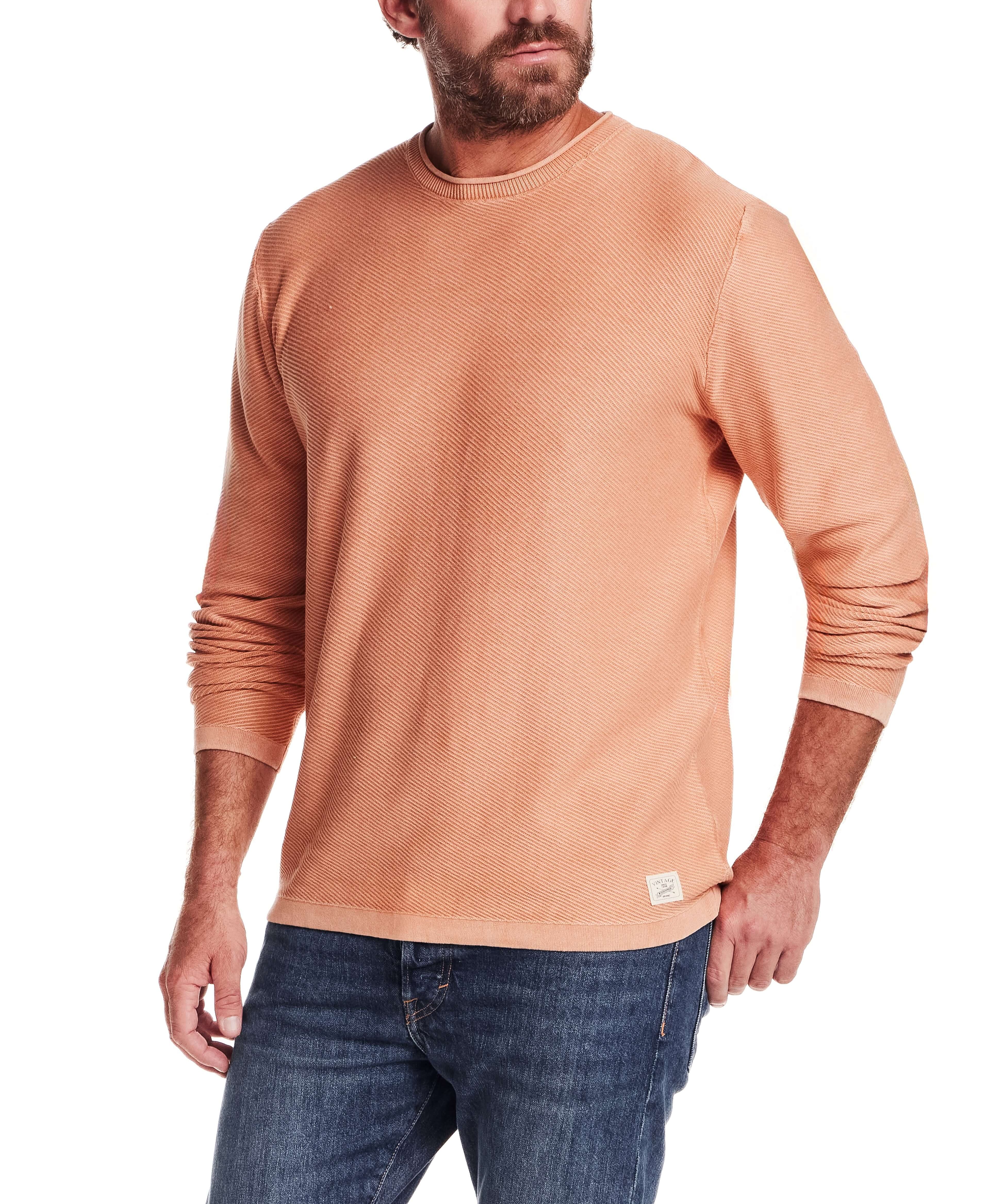 Twill Stonewash Sweater in Shell Coral worn by a man, featuring a classic roll-neck and textured design.