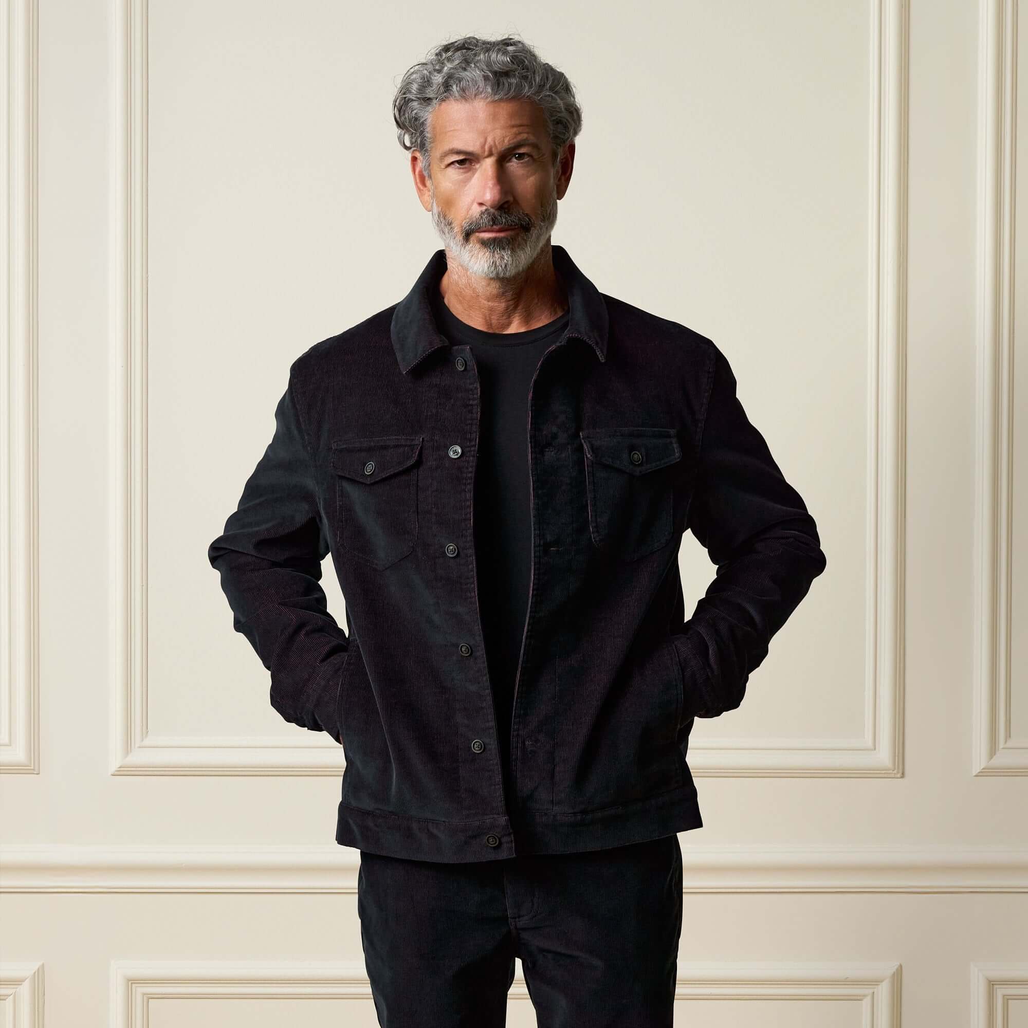 Man wearing a Two-Tone Cord Jacket in Black, showcasing its stylish design and soft texture.