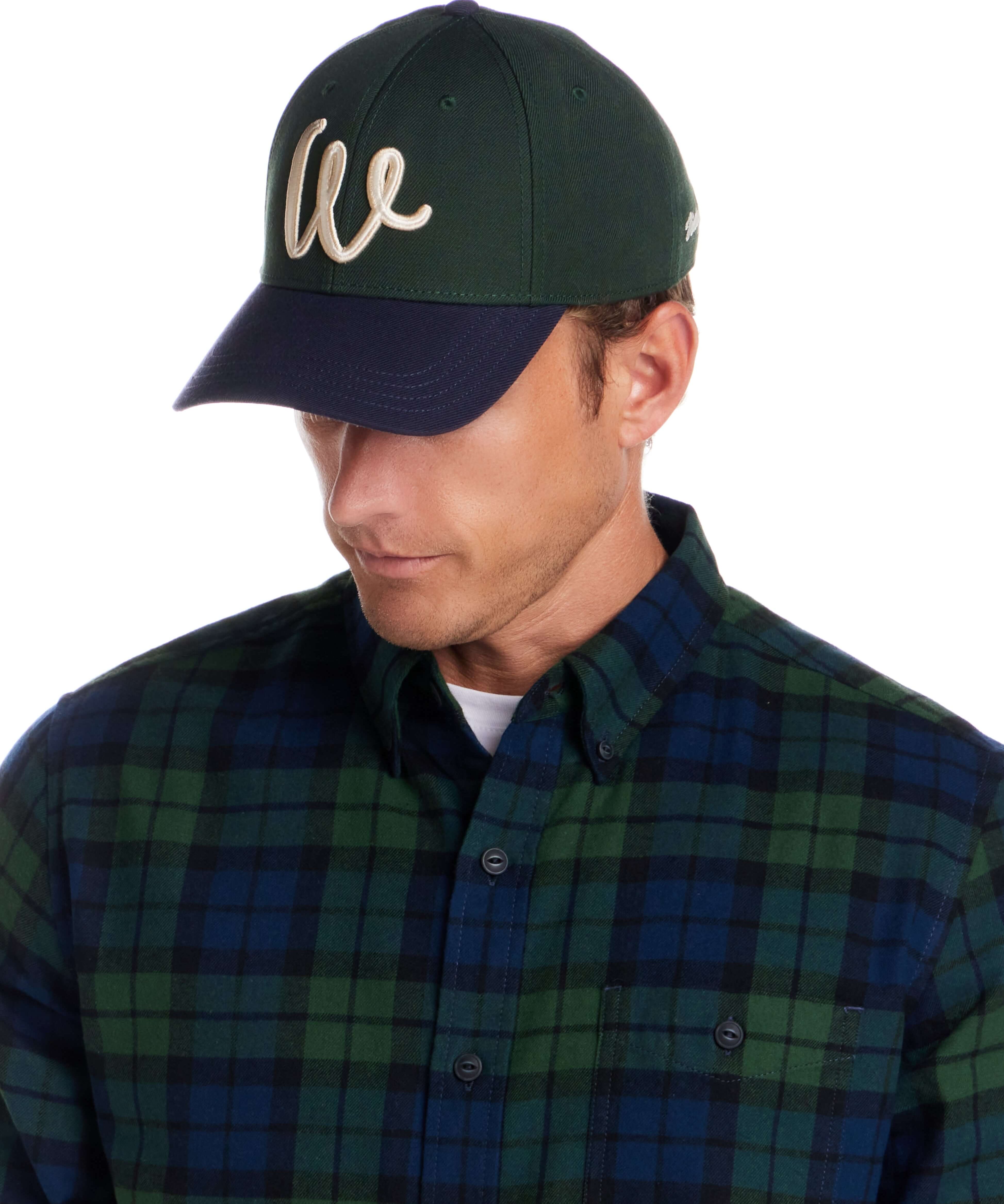 Two Tone Wool Hat in Dark Green and Navy worn by a model with a plaid shirt.