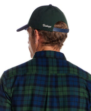 Man wearing a Two Tone Wool Hat in Dark Green and Navy, showcasing the adjustable strap and vintage embroidery.