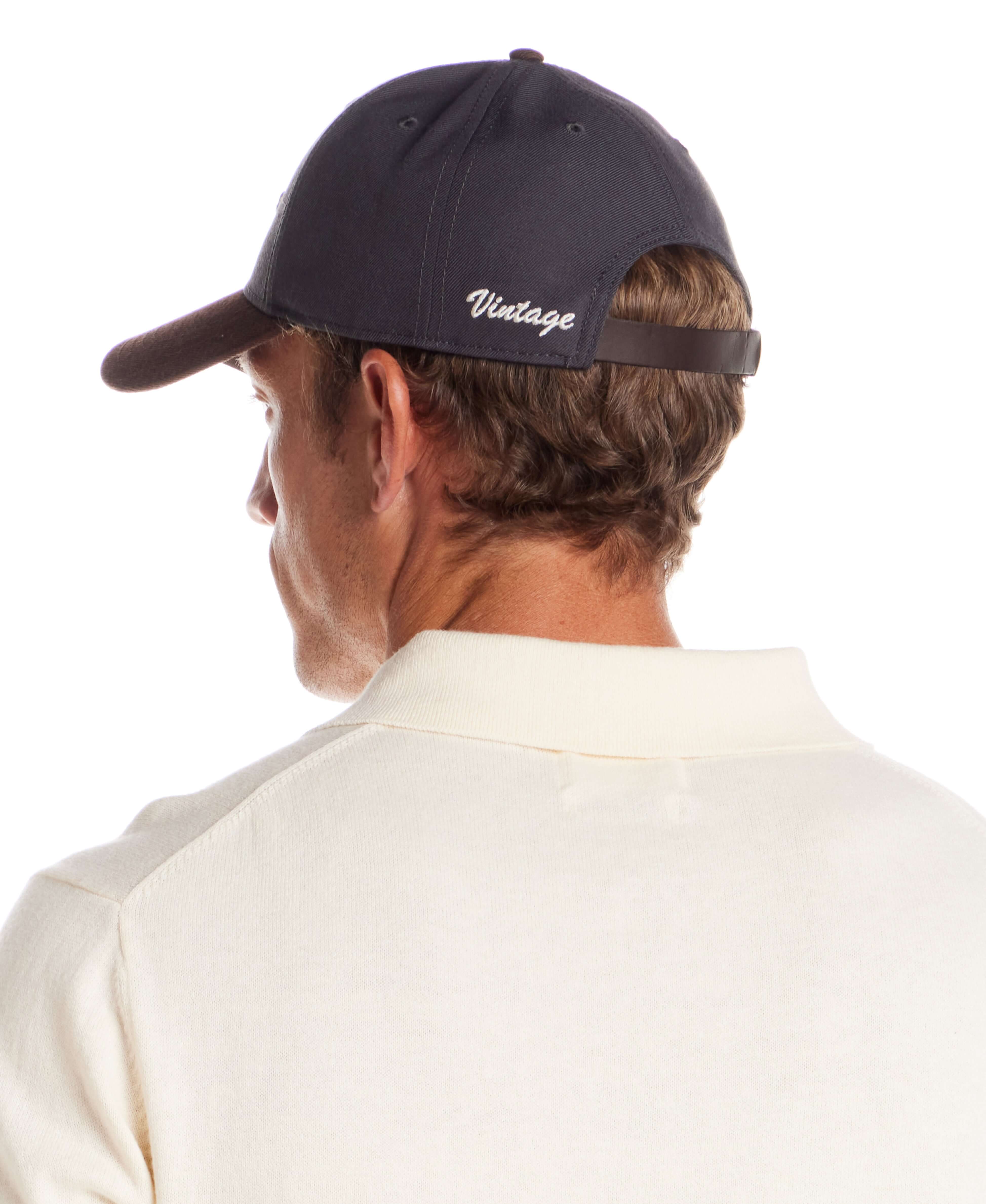 Two Tone Wool Hat in Dark Grey and Brown worn by a man from the back, showcasing adjustable strap and vintage embroidery.