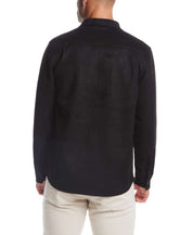 Back view of a man wearing an unlined black sueded shirt jacket, showcasing its soft fabric and stylish design.