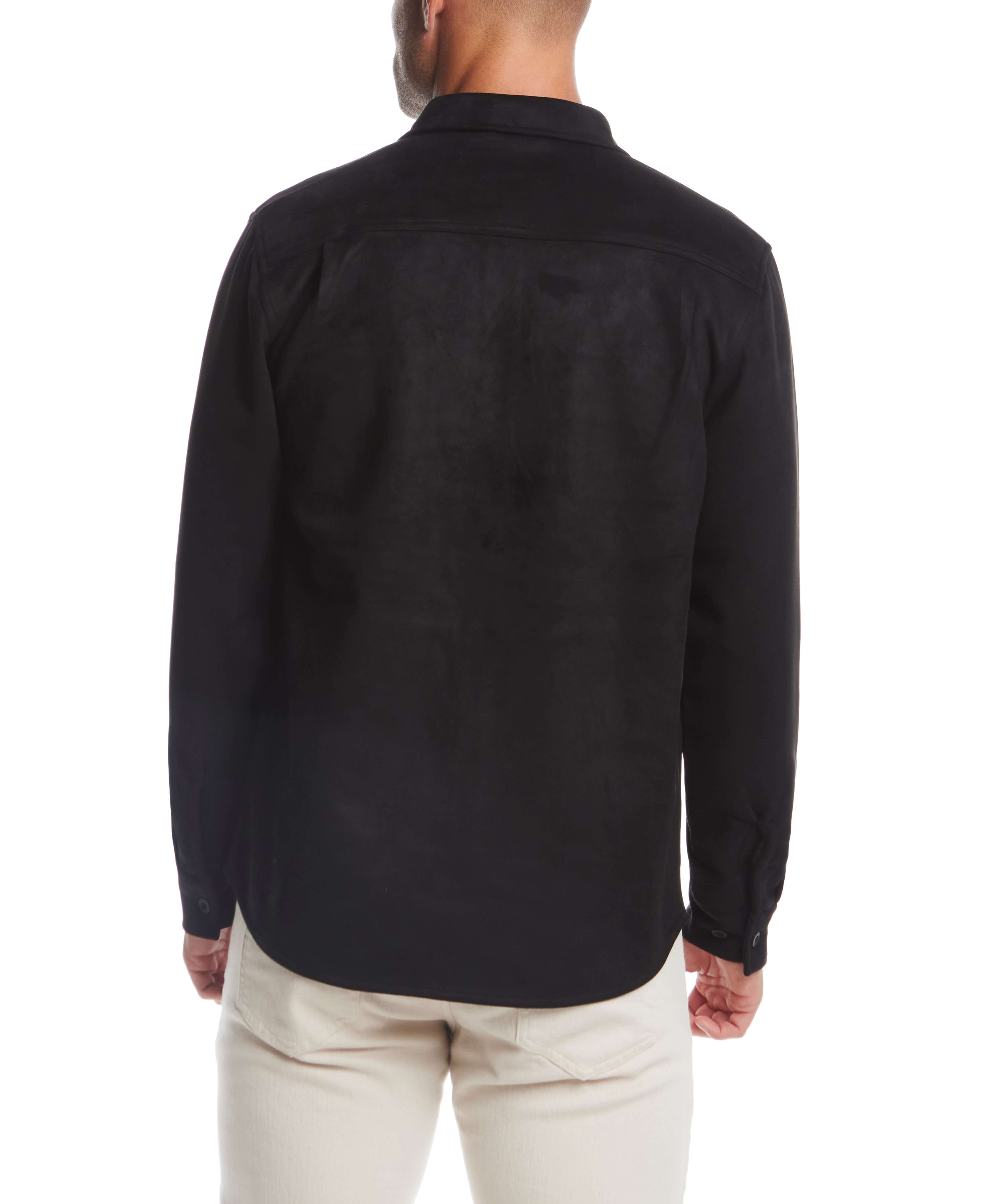 Back view of a man wearing an unlined black sueded shirt jacket, showcasing its soft fabric and stylish design.