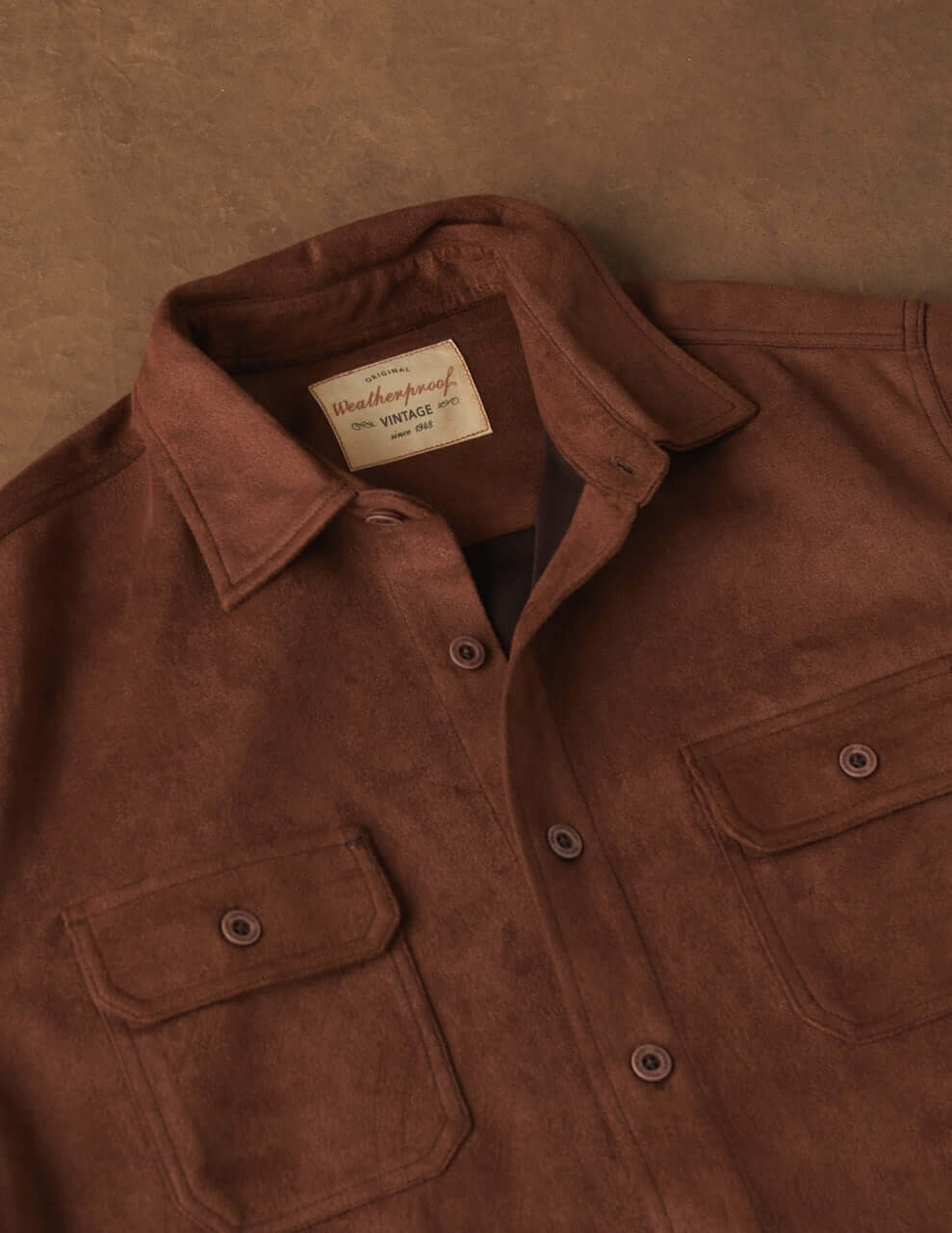 Unlined sueded shirt jacket in light brown with button front and chest pockets, soft and luxurious feel.