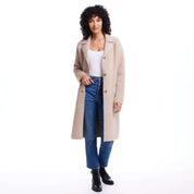 Woman in apricot plush coatigan with button closure and front patch pockets, styled with denim jeans and boots.