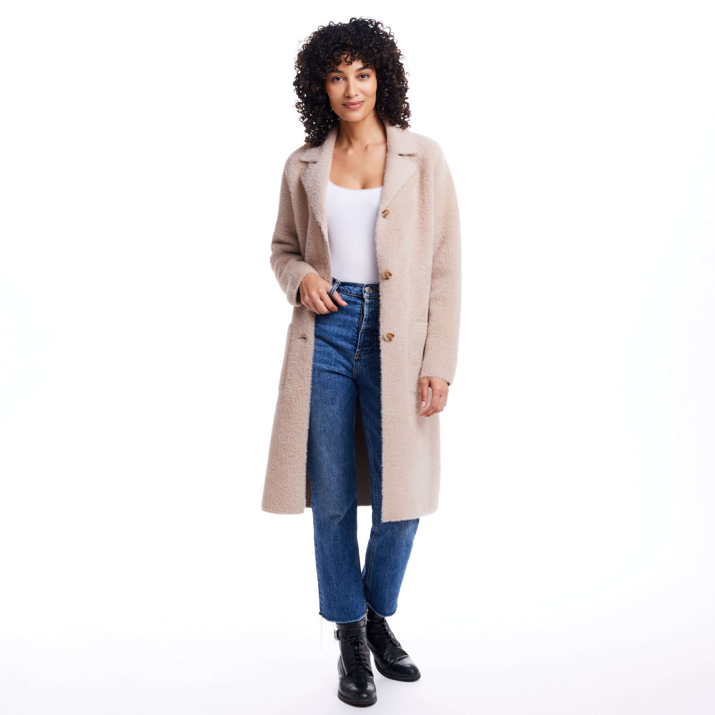 Woman in apricot plush coatigan with button closure and front patch pockets, styled with denim jeans and boots.