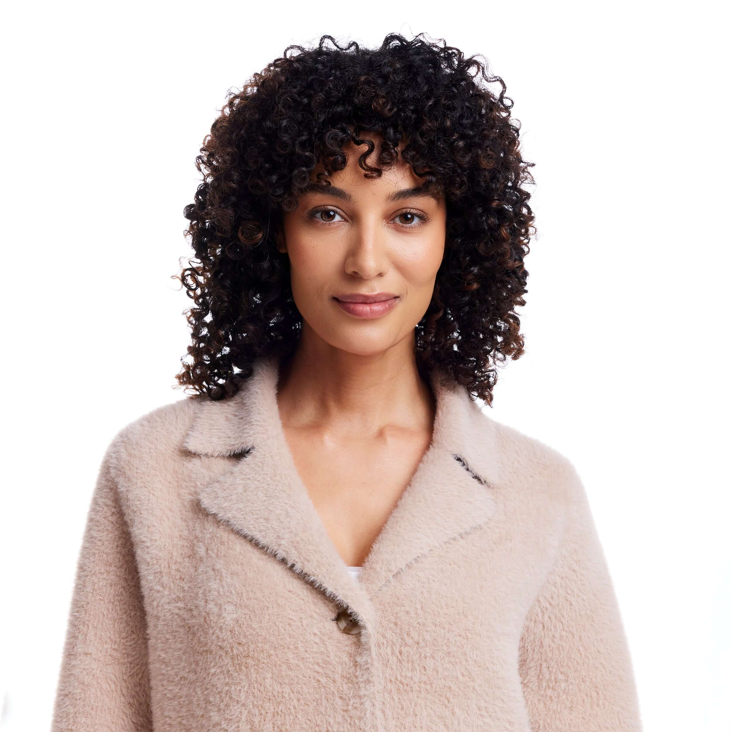 Model wearing Women's Plush Coatigan in apricot, showcasing the soft, stylish fabric and button closure.