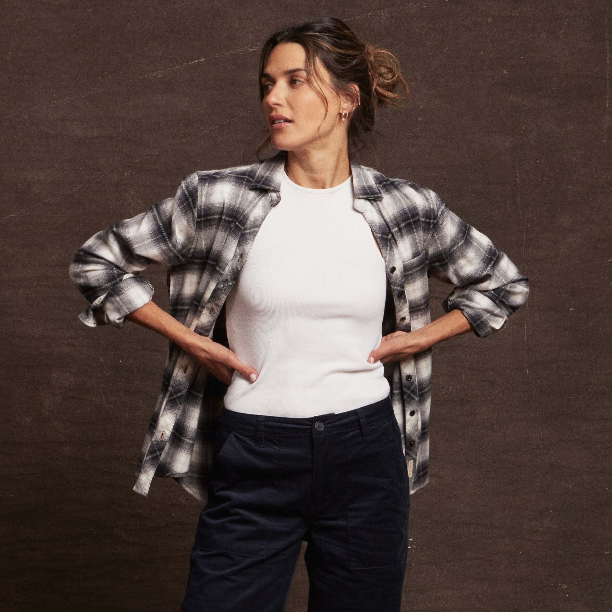 Model showcasing Women's Stretch Flannel in Black, featuring cozy cotton fabric and classic fit with rolled sleeves.
