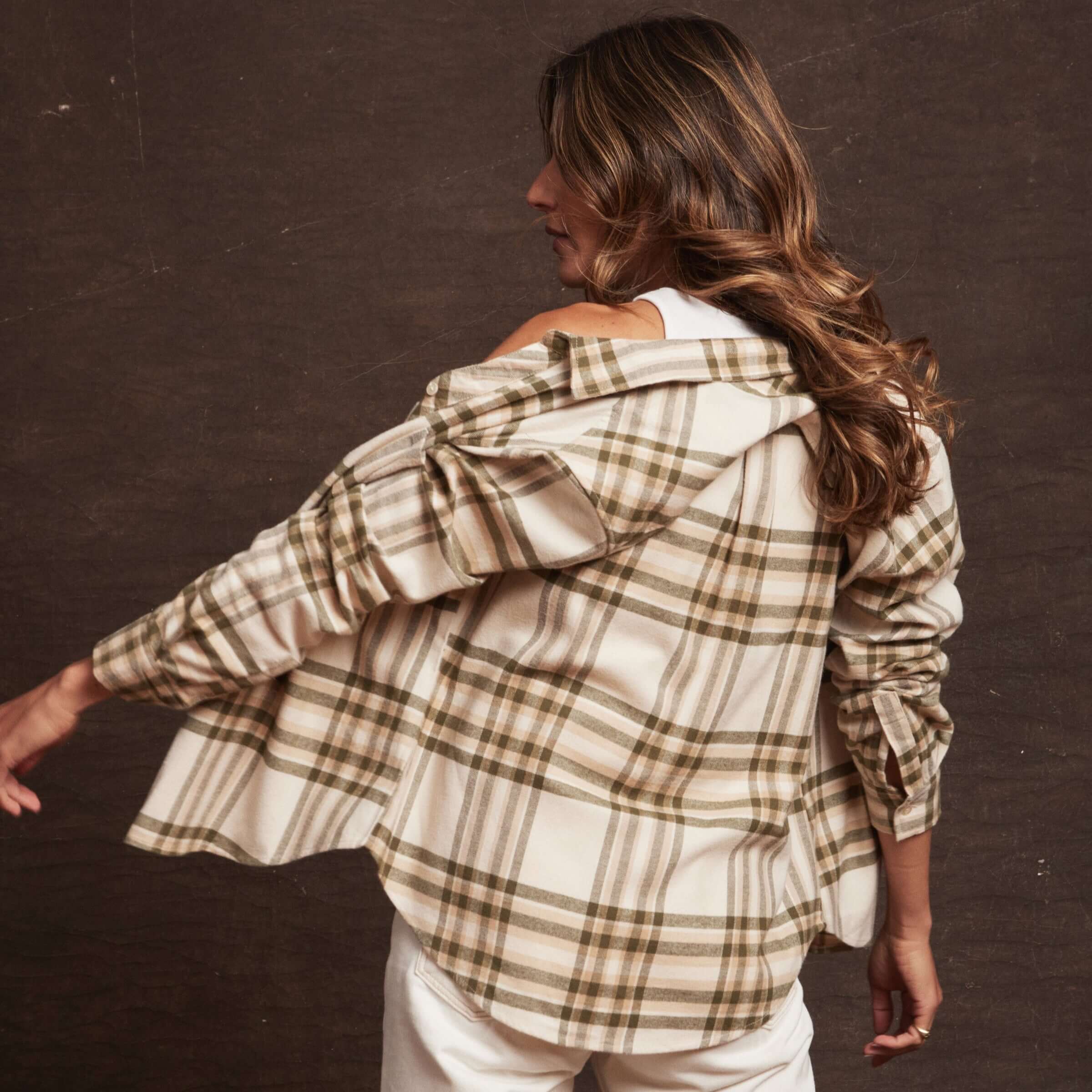 Woman wearing a cozy women's stretch flannel, showcasing double brushed cotton and classic fit with plaid pattern.