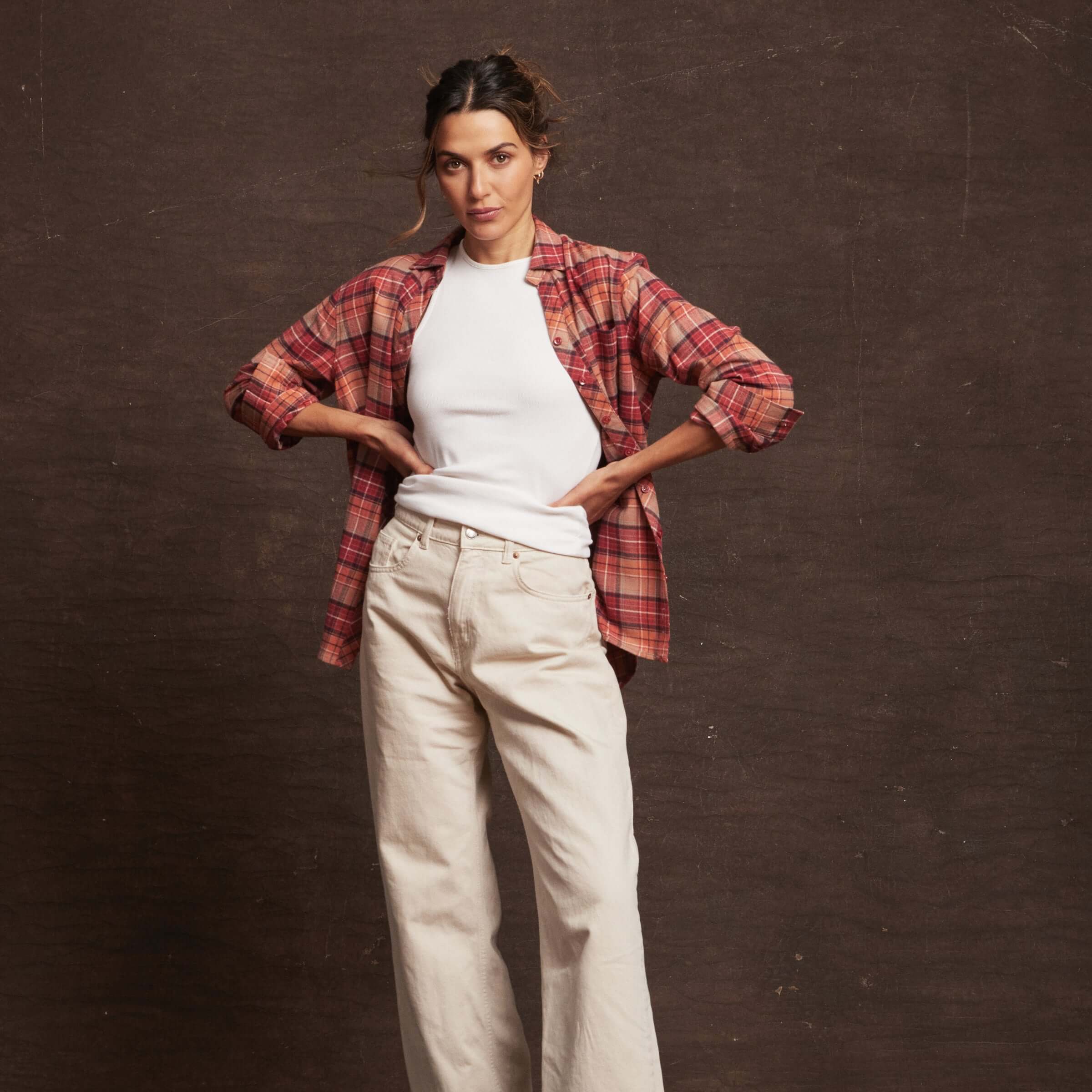Model wearing a Women's Stretch Flannel in Orange with long sleeves, paired with a white t-shirt and light pants.