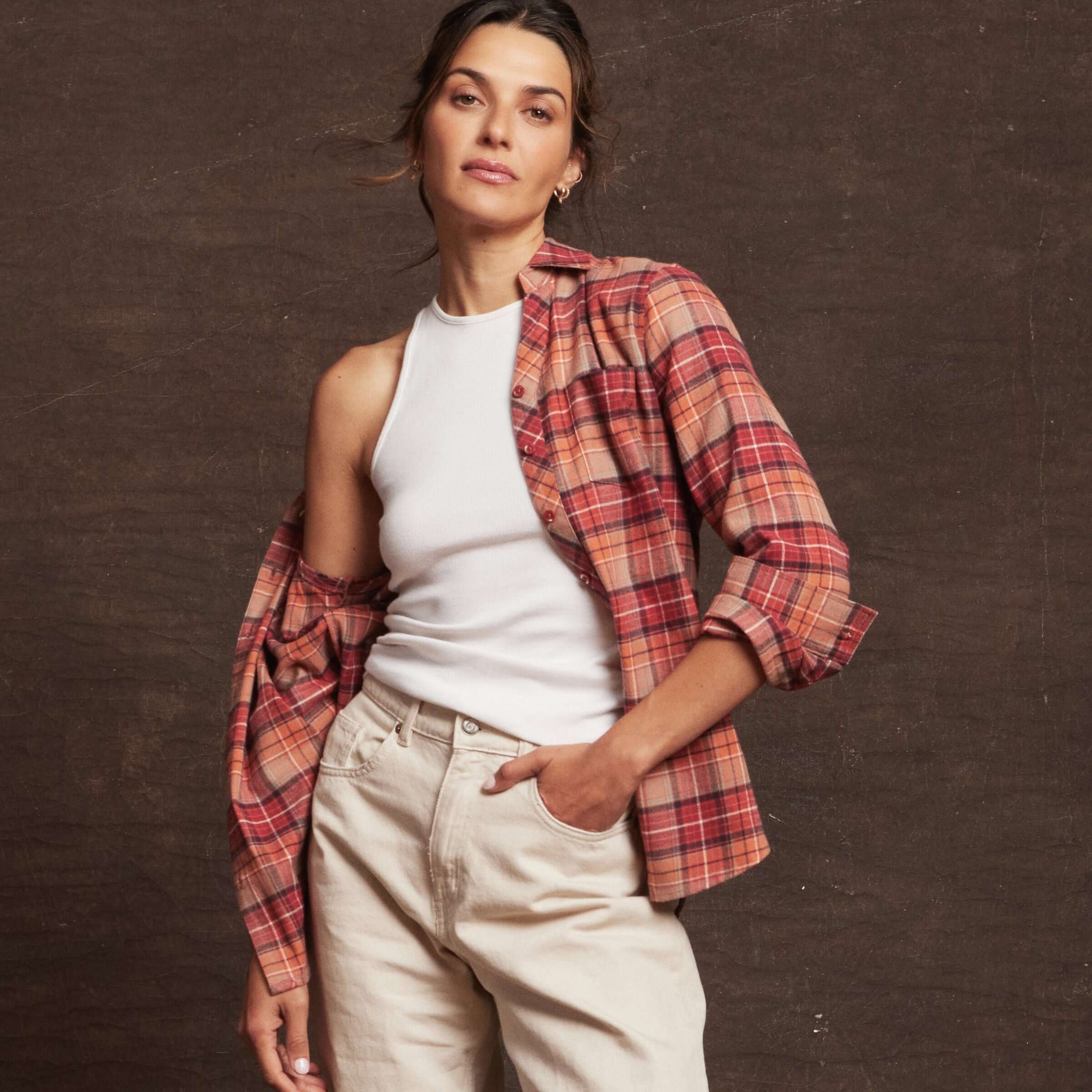 Model wearing a women's orange stretch flannel with a notch V-neck and rolled sleeves, showcasing a cozy classic fit.