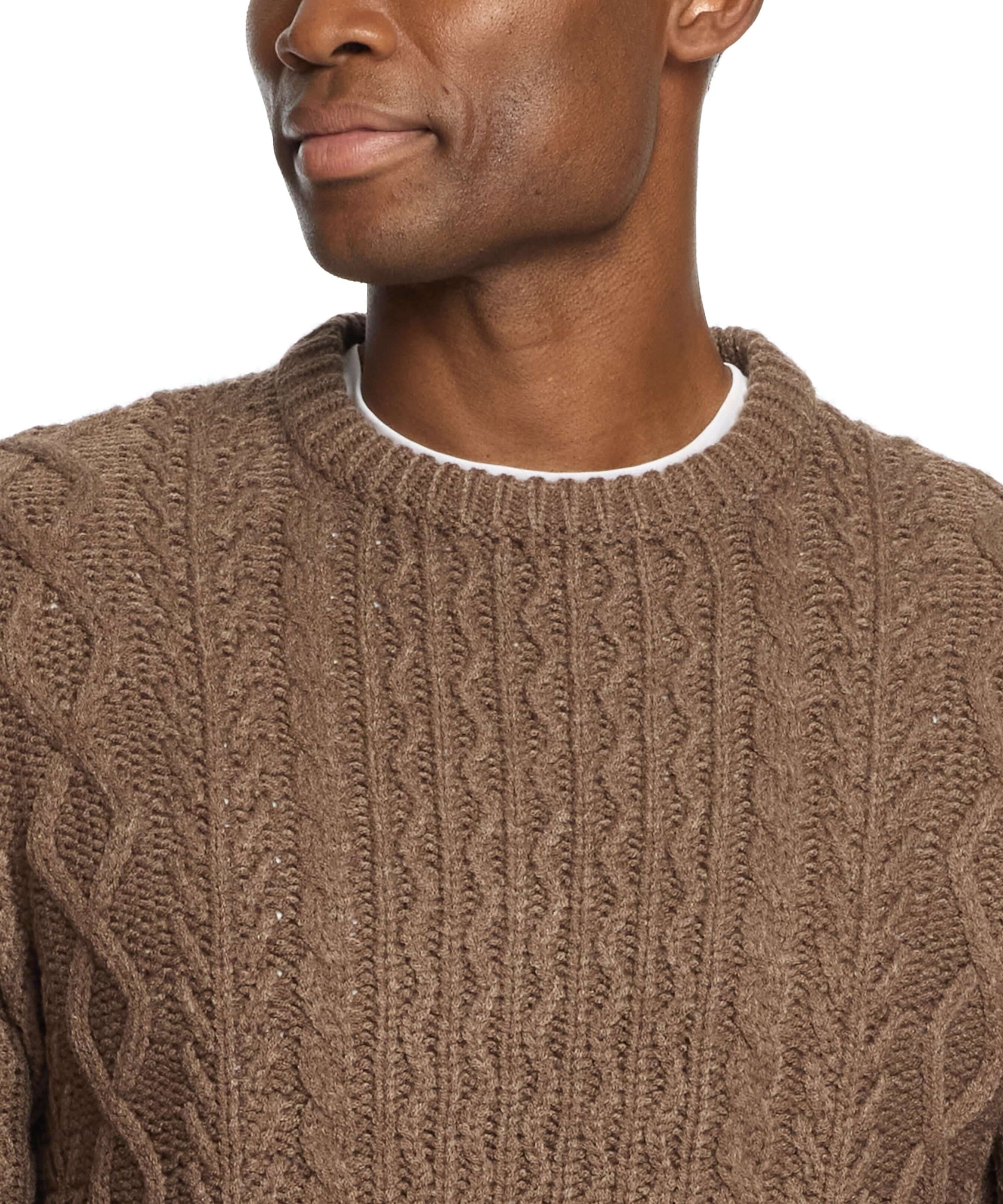Model wearing a brown Zig Zag Cable Knit Crew sweater, showcasing its textured knit design and round neckline.