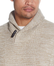 FISHERMAN SHAWL SWEATER IN LIGHT KHAKI showcasing a close-up of the cable pattern and toggle button detail.