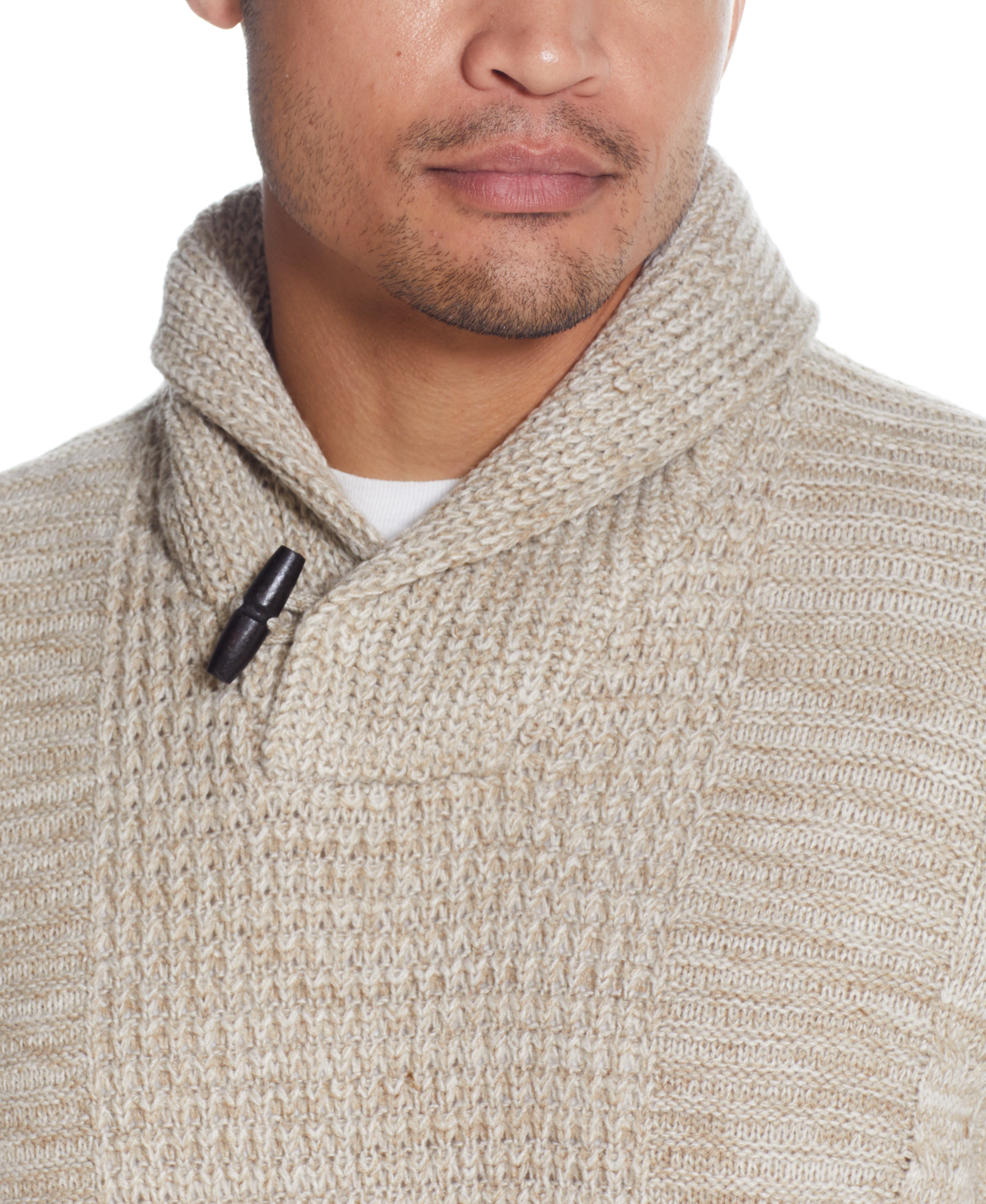 FISHERMAN SHAWL SWEATER IN LIGHT KHAKI showcasing a close-up of the cable pattern and toggle button detail.