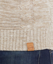 FISHERMAN SHAWL SWEATER IN LIGHT KHAKI showing cable knit detail and rib-knit hem with leather label.