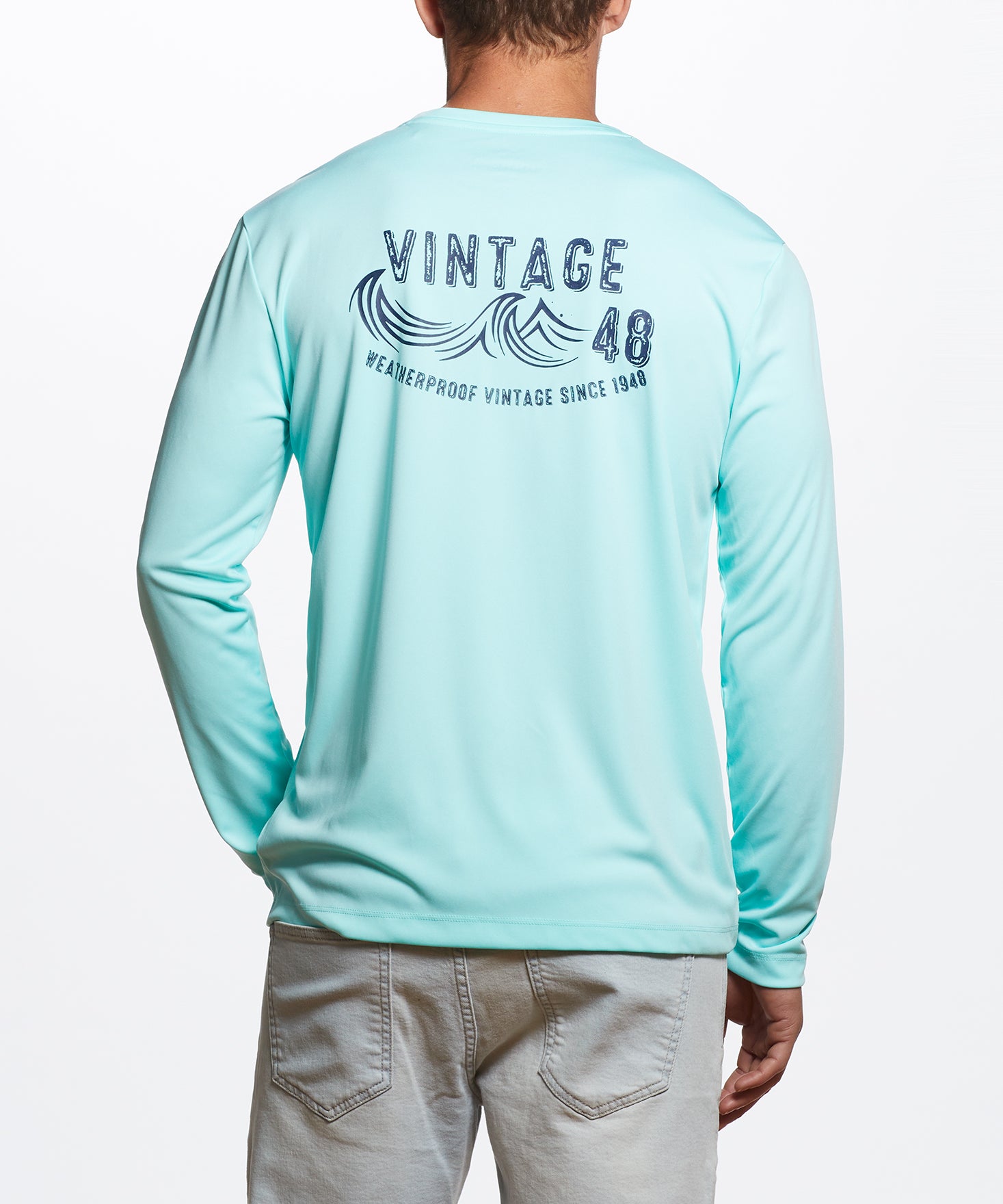 Long Sleeve Sun Shirt Spf In Aruba Blue on a model showcasing a vintage wave graphic, perfect for outdoor adventures.