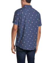 Back view of a man wearing the Peached Poplin Mini Print In Watermelon shirt featuring a playful mini print.